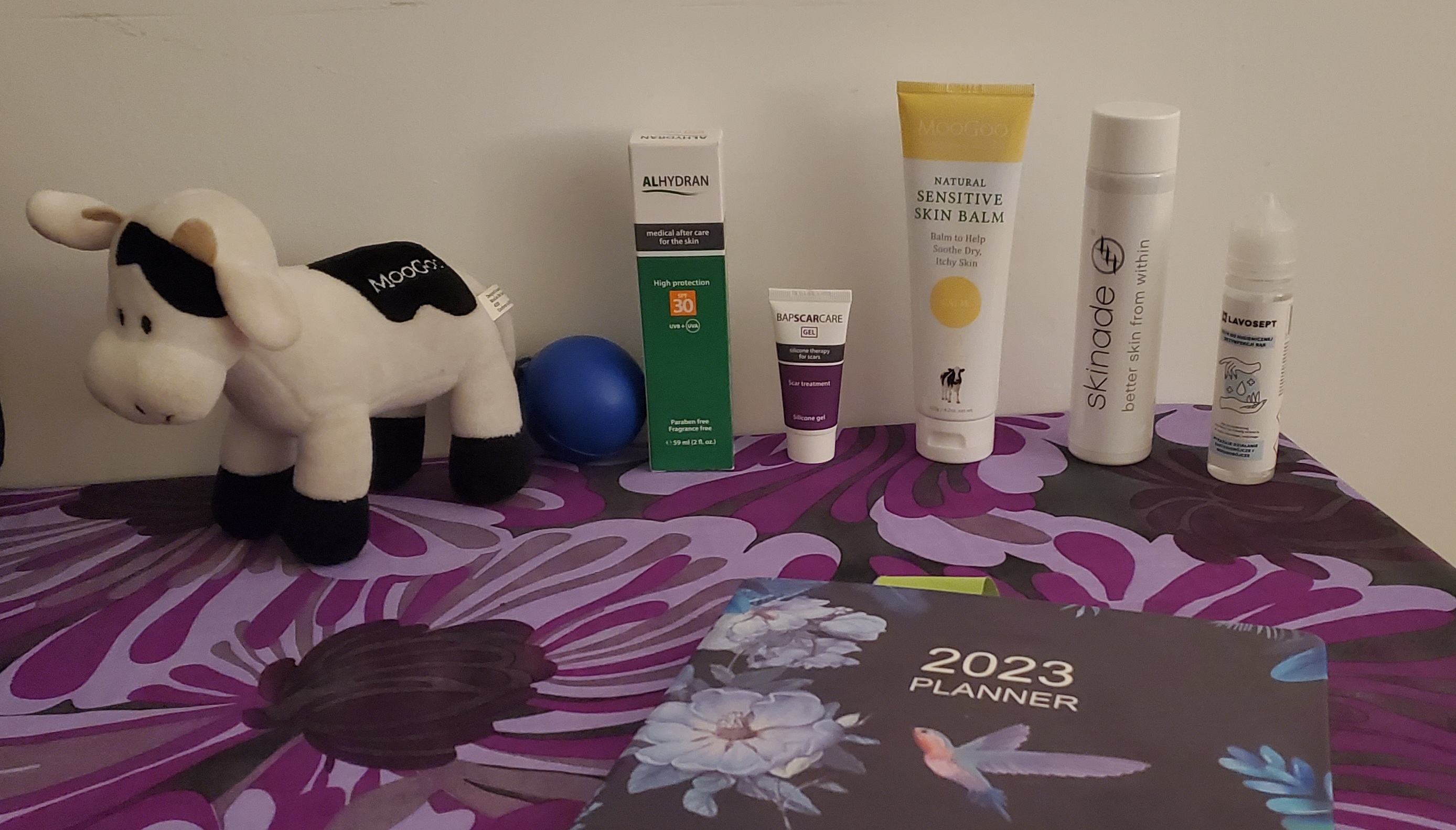 Various products for treatments laid out on a table with a purple table cover.