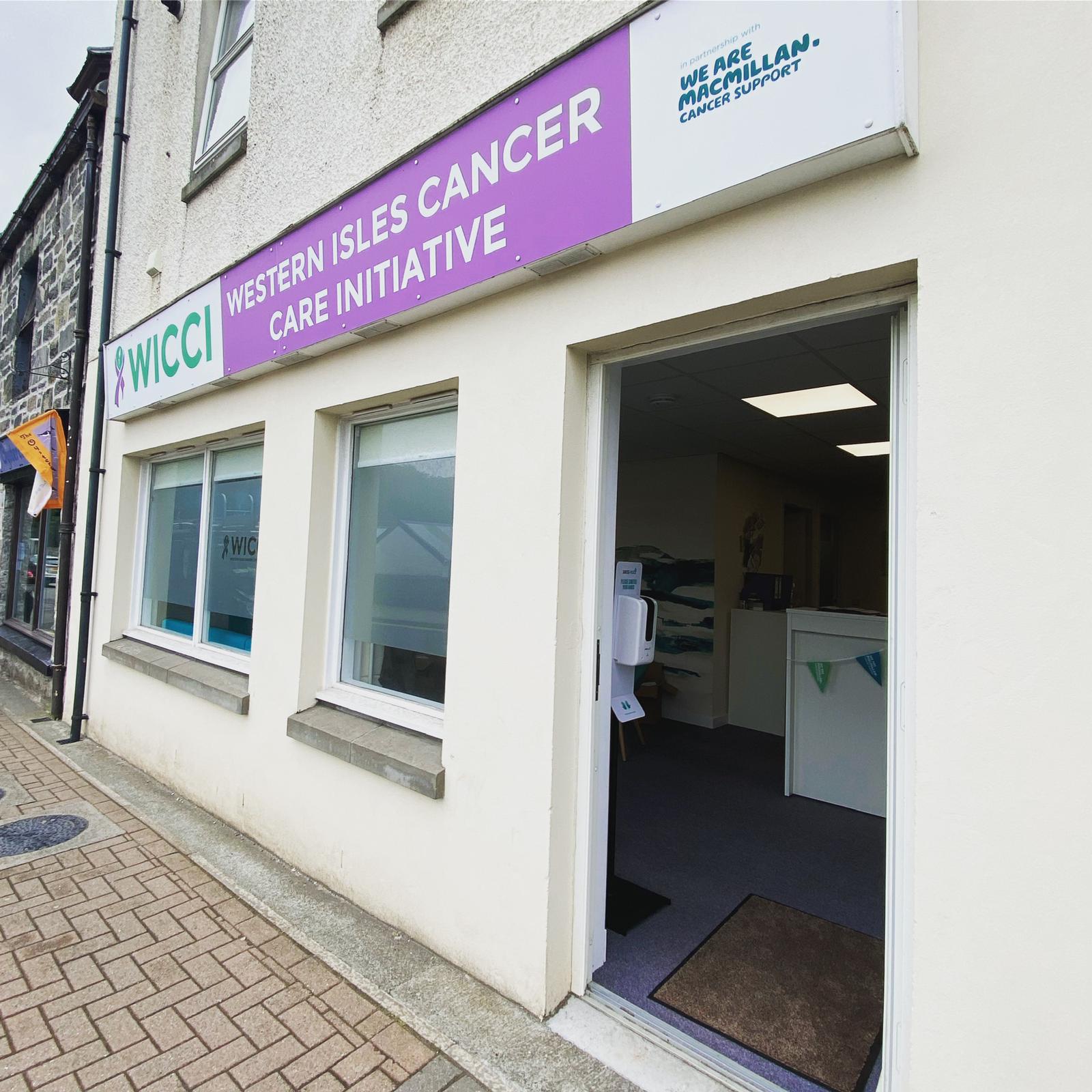 White building with open door with a logo for WICCI Western Isles Cancer Care Initiative 