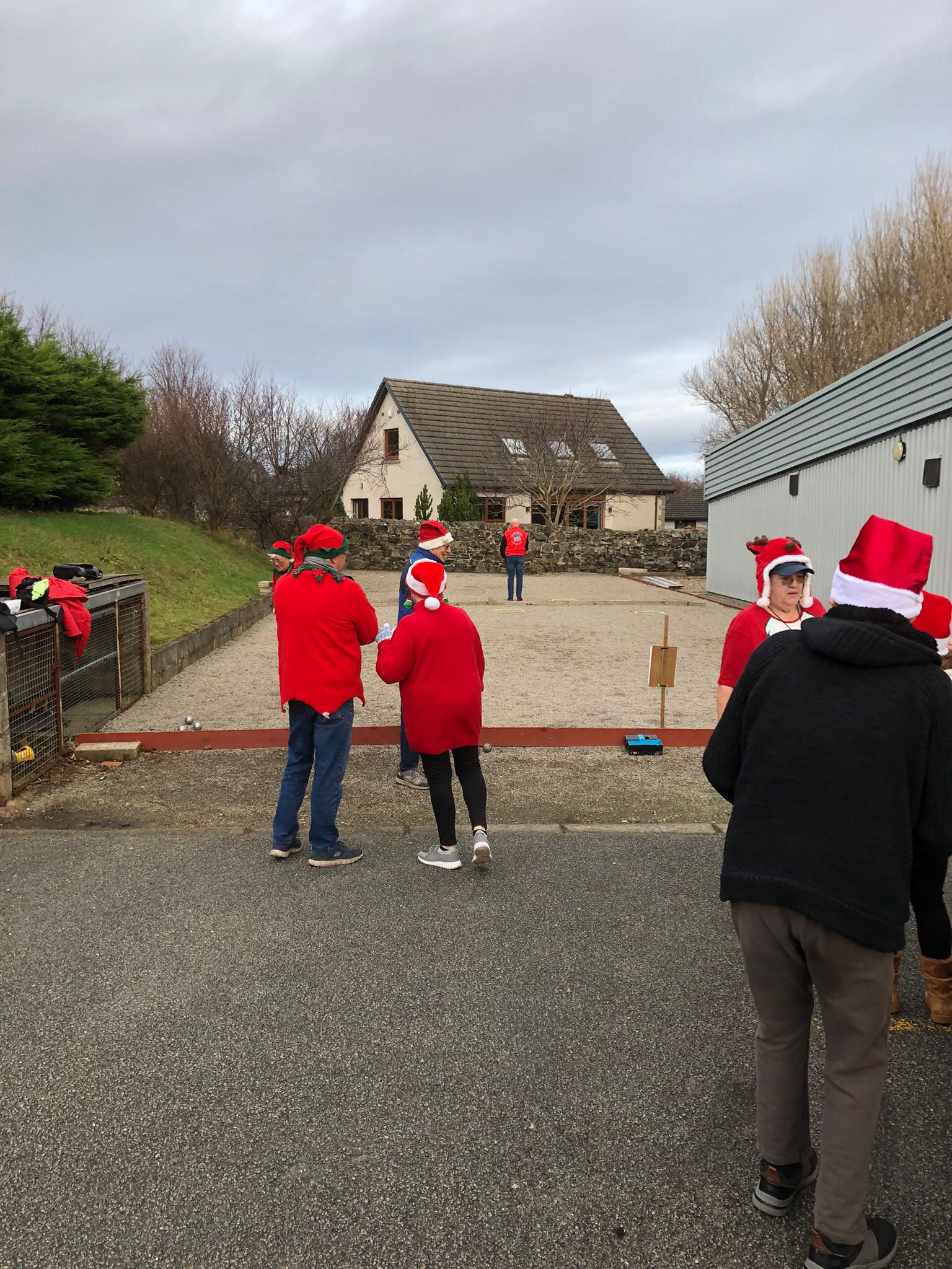 Club members playing Petanque with Santa hats on.